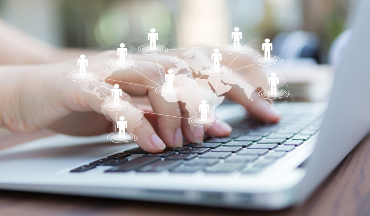 hands-with-laptop-virtual-world-map